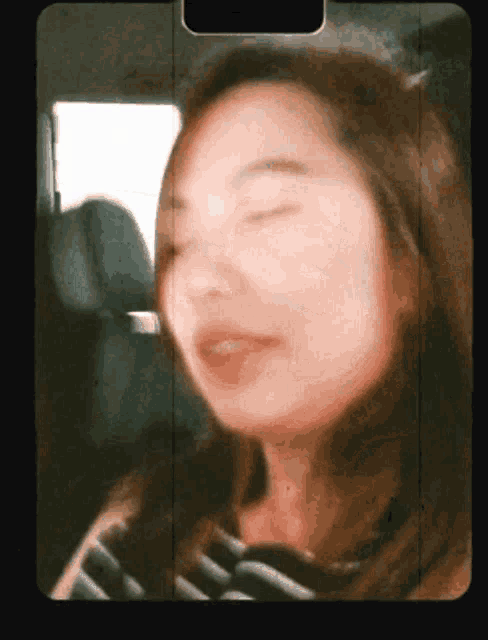 a close up of a woman 's face with the eyes closed