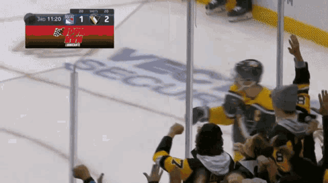 a hockey game is being played with the score 1 to 2