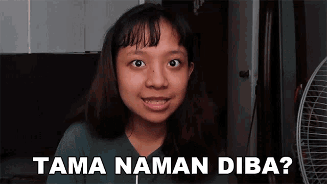 a girl is smiling in front of a fan with the words tama naman diba written below her