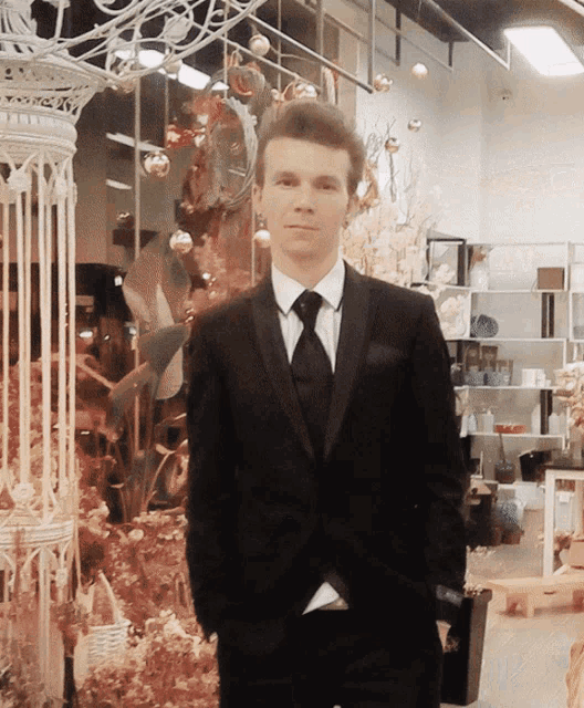 a man in a suit and tie is standing in front of a display