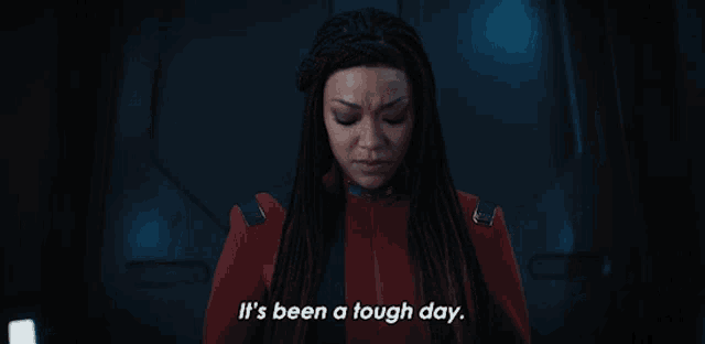 a woman in a red suit is saying it 's been a tough day