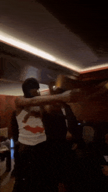 a man and a woman are dancing in a room .