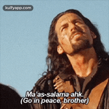 a man with long hair and a beard is holding a guitar and saying go in peace brother