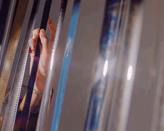 a close up of a person 's hand holding a piece of film that says ' xd ' on it