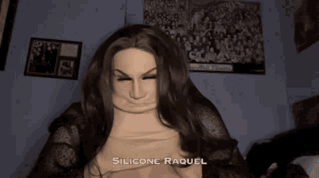 a woman in a silicone raquel mask is making a face