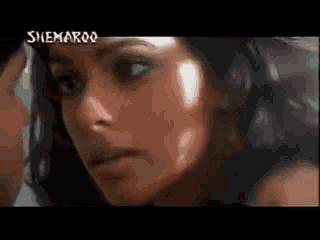 a close up of a woman 's face and a man 's face in a movie .