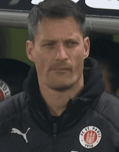 a man wearing a jacket that says fc st. pauli on it