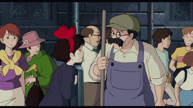 a man with glasses and a mustache stands in a crowd of people