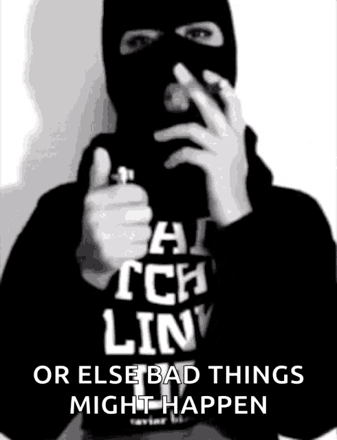 a man wearing a ski mask is holding a lighter in front of his face