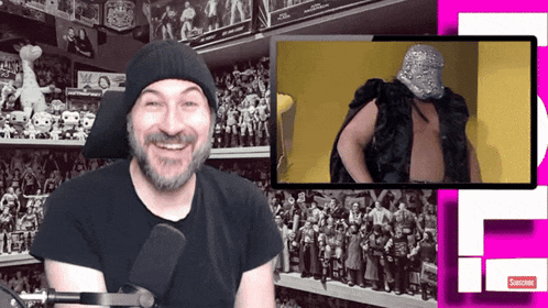 a man with a beard is smiling in front of a sign that says subscribe