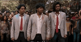 three men in suits and ties are standing in front of a crowd of people
