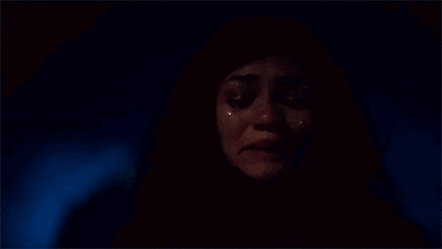 a close up of a woman crying with her eyes closed .