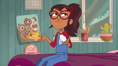 a girl with glasses is sitting on a bed with a picture of a cat on the wall behind her