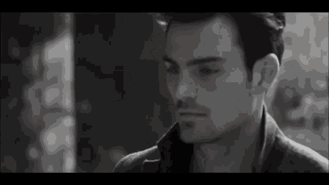 a black and white photo of a man 's face .