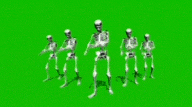 a group of skeletons are walking in a line on a green screen .