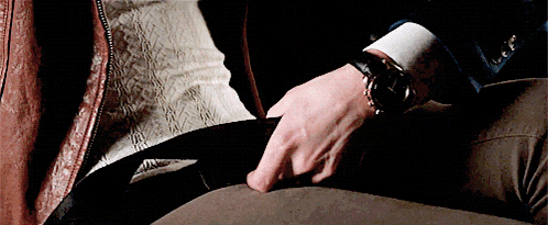 a man wearing a leather jacket and a watch on his wrist