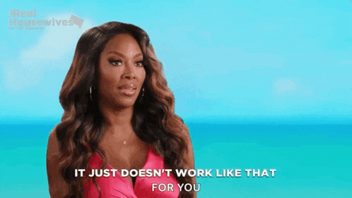 a woman in a pink dress is standing in front of the ocean and saying `` it just does n't work like that for you ''
