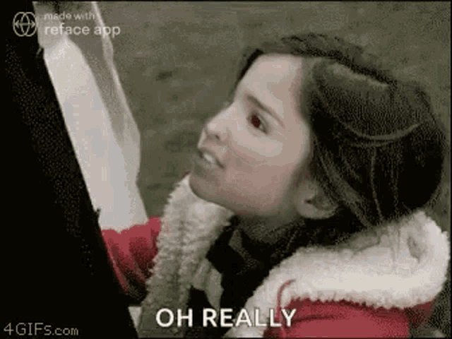 a girl in a red jacket is talking to a man .