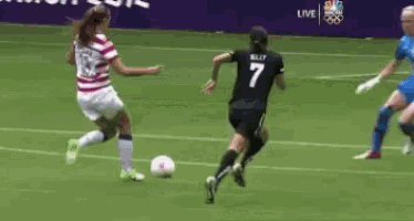 a female soccer player with the number 7 on her jersey is running towards the ball