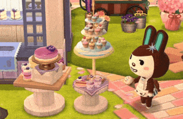 a bunny holding a cupcake in front of a display of cupcakes