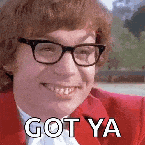 a man wearing glasses and a red jacket is smiling and saying got ya