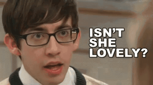 a young man wearing glasses is making a funny face and saying `` isn t she lovely ? ''