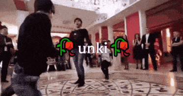 a group of people are dancing in a room with the word unki on the bottom right