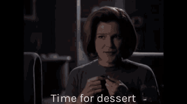 a woman sits in a dark room with the words time for dessert written below her