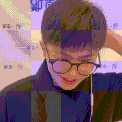 a close up of a person wearing glasses and earbuds .