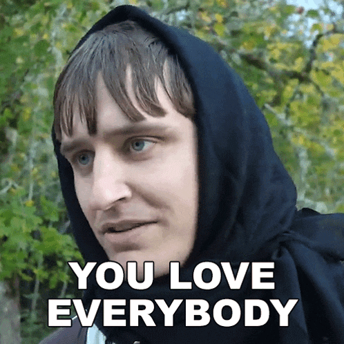 a man wearing a black hoodie with the words you love everybody below him