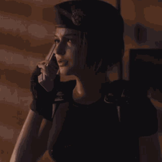 a woman talking on a walkie talkie in the dark