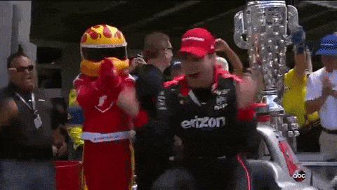 a man wearing a shirt that says ' einzon ' on it is standing in front of a trophy