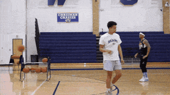 a basketball player wearing a bears shirt dribbles a ball