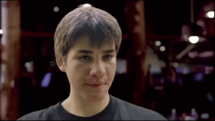a young boy is making a funny face in a blurry photo
