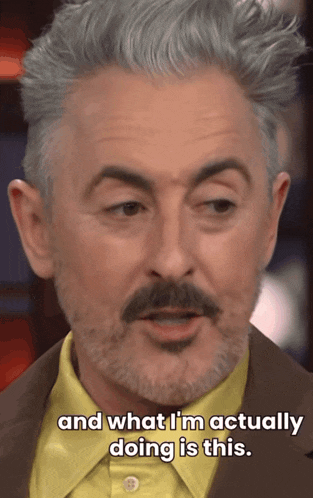 a man with gray hair and a beard is saying " and what i 'm actually doing is this "