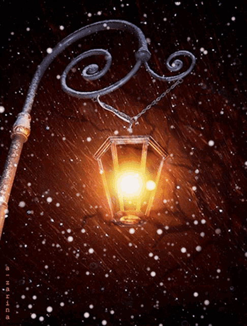 a lantern hanging from a pole with a swirl on the top of it