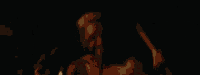 a shirtless man with white hair is laying down in a dark room .