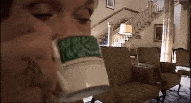 a person is drinking from a mug that says marshmellow