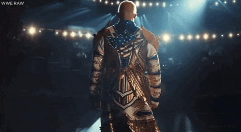 a man in a wrestling outfit is standing in front of a crowd with the words wwe raw on the bottom