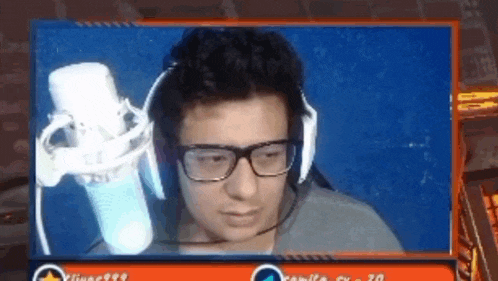 a man wearing glasses and headphones is looking at the camera .