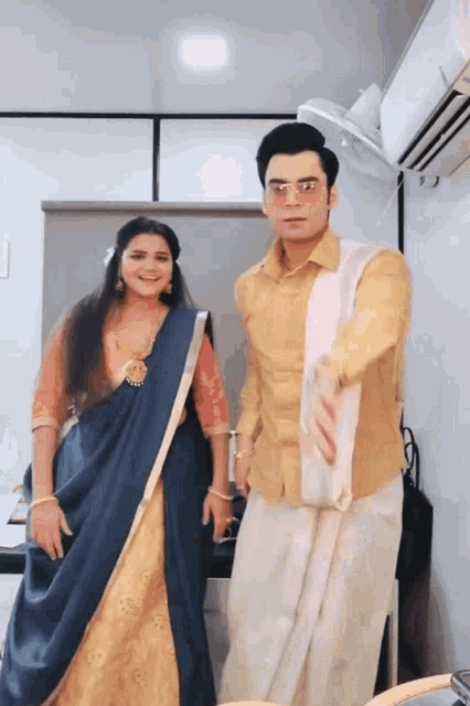 a man and a woman are dancing in a room