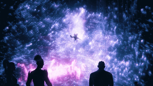 a group of people are standing in front of a purple light