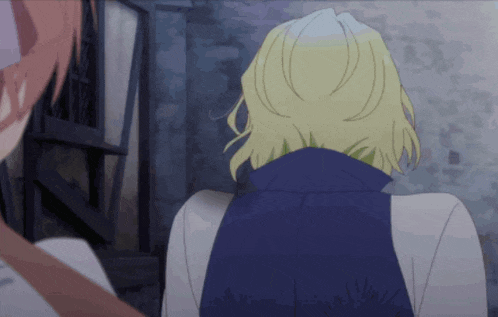 a woman with blonde hair is standing next to a man in a blue jacket