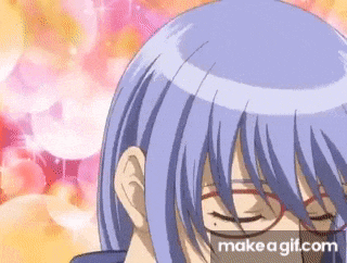 a close up of a person 's face wearing glasses and purple hair .