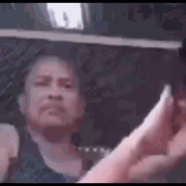 a person is taking a picture of a woman 's face in a car window .