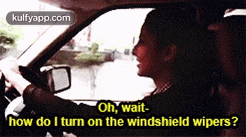 a woman is driving a car and asking how do i turn on the windshield wipers .