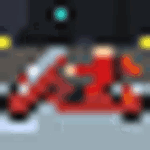 a pixel art illustration of a man riding a red motorcycle on a street .