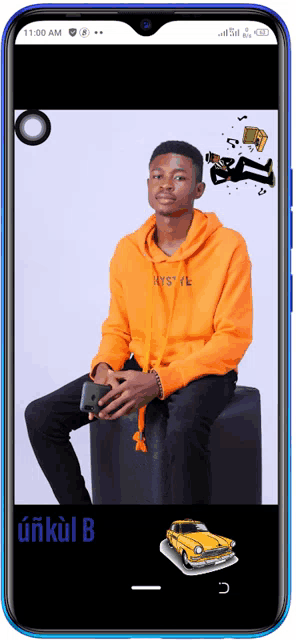 a man in an orange hoodie is sitting on a stool on a cell phone screen