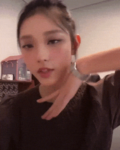 a woman wearing a black shirt has a bracelet around her neck