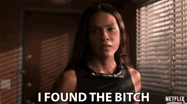 a woman says " i found the bitch " in front of blinds
